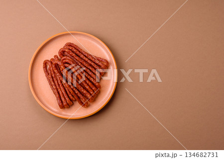 Smoked cabanossi, thin salami sausage, meat sticks, or snacks. Cabanossi sausage Smoked cabanossi, thin salami sausage, meat sticks, or snacks. Cabanossi sausage 134682731