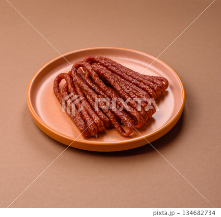 Smoked cabanossi, thin salami sausage, meat sticks, or snacks. Cabanossi sausage Smoked cabanossi, thin salami sausage, meat sticks, or snacks. Cabanossi sausage 134682734