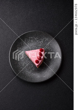 Raspberry or strawberry cheesecake, a slice of sweet red cake with berries. Raspberry cheesecake 134682978