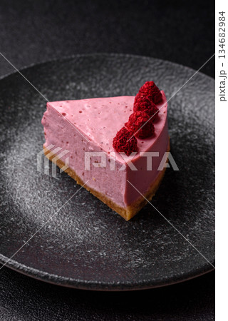 Raspberry or strawberry cheesecake, a slice of sweet red cake with berries. Raspberry cheesecake 134682984