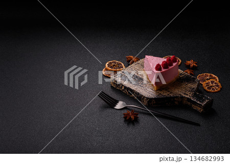 Raspberry or strawberry cheesecake, a slice of sweet red cake with berries. Raspberry cheesecake Raspberry or strawberry cheesecake, a slice of sweet red cake with berries. Raspberry cheesecake 134682993