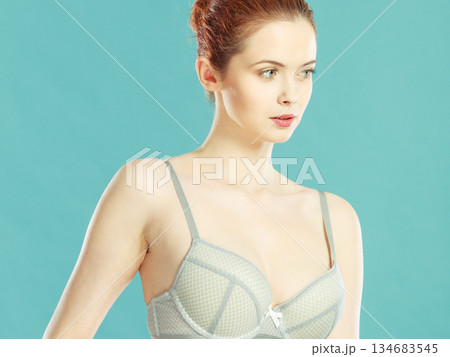 Woman in bra lingerie taking care of her breasts 134683545