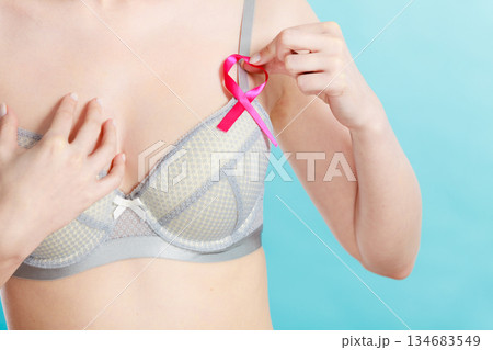 woman in bra with breast cancer awareness ribbon 134683549