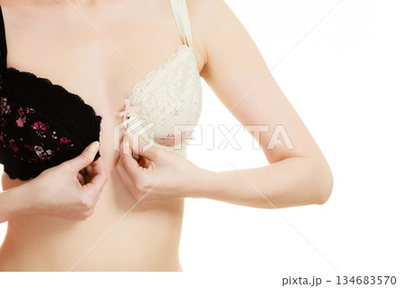 Lady with choice trying to choose perfect bra. 134683570