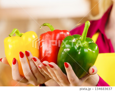 Woman holding bell peppers paprika 134683637