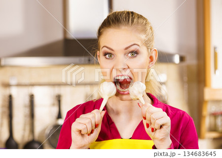 Crazy girl eating garlic vegetable Crazy girl eating garlic vegetable 134683645
