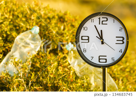 Clock ticking on polluted nature. Ecology Clock ticking on polluted nature. Ecology 134683745