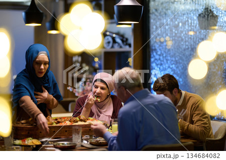 Muslim family breaks their fast together in a decorated restaurant during Ramadan Muslim family breaks their fast together in a decorated restaurant during Ramadan 134684082