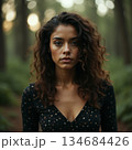 AI generated Contemplative female in woodland, Reflective woman with curly hair in forest 134684426
