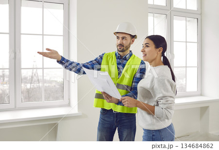 Foreman showing house design plan to apartment owner Foreman showing house design plan to apartment owner 134684862