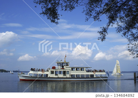 Steamboat with tourists at Chiemsee, Chiemgau, Bavaria, Germany Steamboat with tourists at Chiemsee, Chiemgau, Bavaria, Germany 134684892