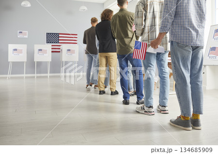 Group of people registering at polling station standing in a queue at vote center. 134685909