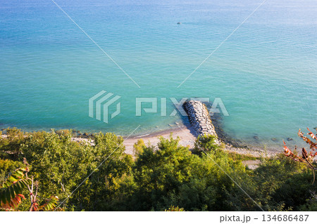 Aerial View of Turquoise Lake Water and Rocky Breakwater Aerial View of Turquoise Lake Water and Rocky Breakwater 134686487
