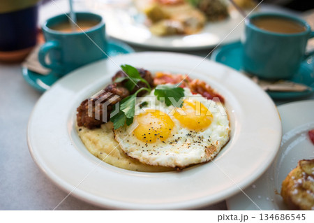 Sunny Side Up Eggs with Sausage and Grits Sunny Side Up Eggs with Sausage and Grits 134686545