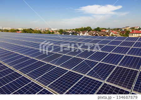 Office building with solar roof. Blue photovoltaic panels for producing clean ecological electric energy. Investing in renewable electricity concept 134687879