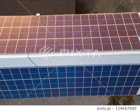 Office building with solar roof. Blue photovoltaic panels for producing clean ecological electric energy. Investing in renewable electricity concept. 134687880