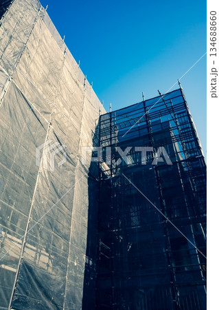 ビル建設中の養生幕と足場　a-3 暖色寒色強調 134688660