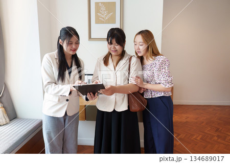Real Estate Collaboration. Clients discussing property options with agent. Real Estate Collaboration. Clients discussing property options with agent. 134689017