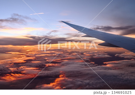 飛行機の機内から撮影した美しい夕焼けの風景写真 134691025