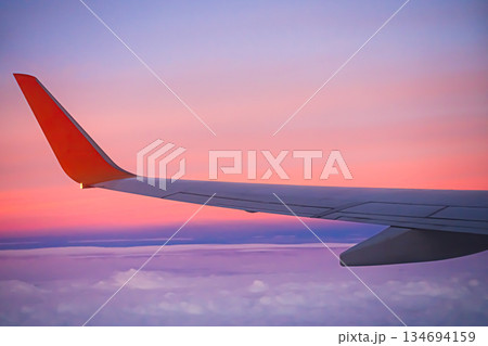 Flight Plane Fly Sky Cloud Sunset View Background, Airplance Wing Aircraft Silhouette Sunrise Gradient Pastel Orange Sunlight, Ket;omer Avoatopm Commercial Transport Tourism Business Corperate Travel. 134694159