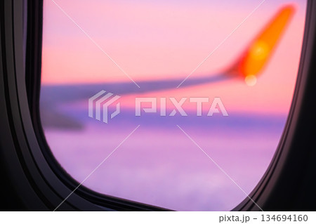 Flight Plane Fly blur Sky Cloud Sunset View Background, Airplance Wing Aircraft Silhouette Sunrise Gradient Pastel Orange Sunlight, Ket;omer Avoatopm Commercial Transport Tourism Corperate Travel. Flight Plane Fly blur Sky Cloud Sunset View Background, Airplance Wing Aircraft Silhouette Sunrise Gradient Pastel Orange Sunlight, Ket;omer Avoatopm Commercial Transport Tourism Corperate Travel. 134694160