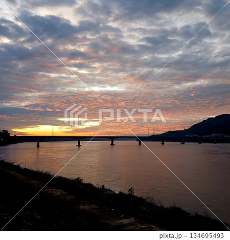 Silhouette Lao Nippon Bridge with mountain with cloud and sky in magic hour at sunrise at Mekong River in Pakse, Laos Silhouette Lao Nippon Bridge with mountain with cloud and sky in magic hour at sunrise at Mekong River in Pakse, Laos 134695493