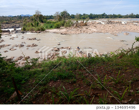 Waterfall with rocky rapids in the Mekong River at Khone Phapheng, in Laos Waterfall with rocky rapids in the Mekong River at Khone Phapheng, in Laos 134695496