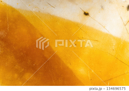 Yellow orange encaustic wax art texture background with abstract pattern, macro photography showing smooth surface, subtle cracks, and organic color gradient, creative and vibrant mood 134696575