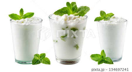 Ayran salted yogurt drink in tall glass with foamy top and mint leaf, isolated on white background, concept of healthy drink 134697241