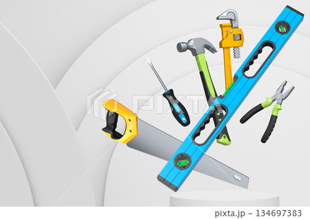 Construction tools and safety equipment floating over podium on abstract background, industrial work and protection concept Construction tools and safety equipment floating over podium on abstract background, industrial work and protection concept 134697383