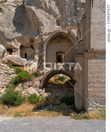 Ancient rock-cut structures and cave dwellings in Cavusin Old Village, Cappadocia, Turkey 134697427