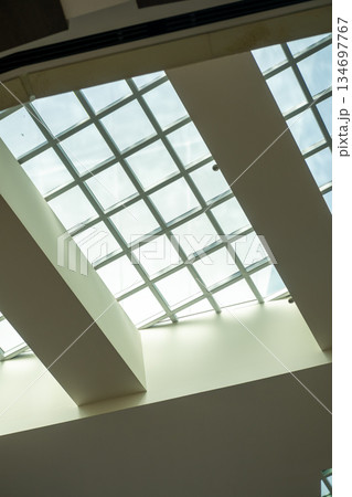 Abstract, minimalist, modern architectural space with concrete walls and opening skylight Abstract, minimalist, modern architectural space with concrete walls and opening skylight 134697767