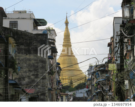 The Gold Dome of Shwedagon Pagoda behind residential buildings in Yangon The Gold Dome of Shwedagon Pagoda behind residential buildings in Yangon 134697954