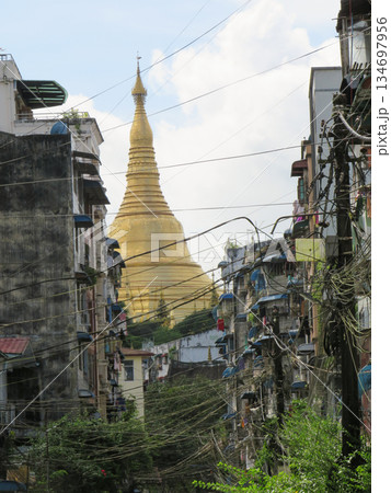 The Gold Dome of Shwedagon Pagoda behind residential buildings in Yangon 134697956