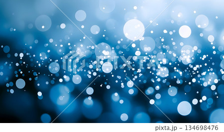 Abstract blue bokeh background with shimmering light particles creating a magical and festive atmosphere Abstract blue bokeh background with shimmering light particles creating a magical and festive atmosphere 134698476