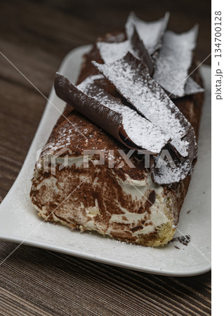Tiramisu Tronchetto Dessert, Italian Yule Log Christmas dessert with chocolate bark 134700128
