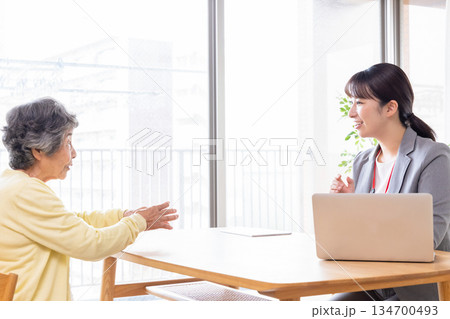 シニア女性に説明するビジネスウーマン シニア女性に説明するビジネスウーマン 134700493