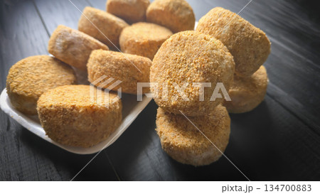 Freshly frozen breaded fish cakes. Round, semi-finished products, ready to cook. Freshly frozen breaded fish cakes. Round, semi-finished products, ready to cook. 134700883