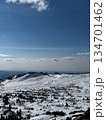 Wide snowy mountain view with blue sky and rocky peaks in winter. 134701462