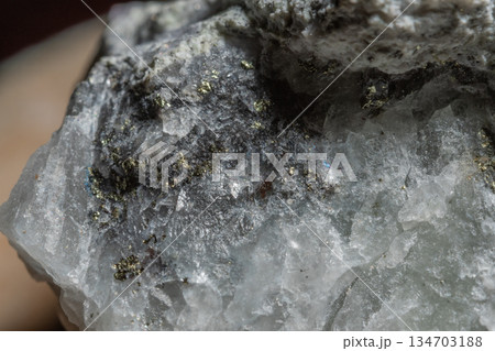 Close-up of stone with clear crystals and dark inclusions Close-up of stone with clear crystals and dark inclusions 134703188