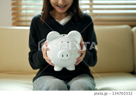 Saving money with piggy bank Saving money with piggy bank 134703332