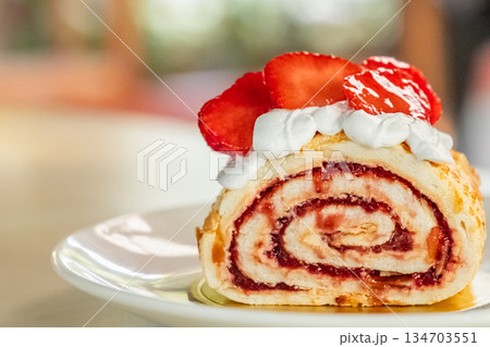 Swiss roll with strawberries. Cake slice cream with strawberry Swiss roll with strawberries. Cake slice cream with strawberry 134703551