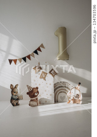 Animal themed party decorations, banner and large number one balloon set the stage for baby's first birthday celebration. Animal themed party decorations, banner and large number one balloon set the stage for baby's first birthday celebration. 134703596