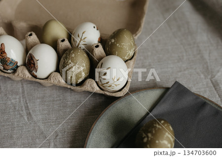 Easter holiday. Painted olive-colored eggs on a linen tablecloth. Easter decoration. Easter holiday. Painted olive-colored eggs on a linen tablecloth. Easter decoration. 134703600