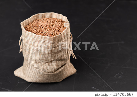 a bag of buckwheat on a black background a bag of buckwheat on a black background 134703667