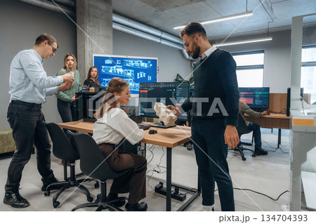 Employees are together. People are in the office by the 3d printer 134704393