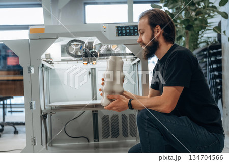 Product is ready. Man is in the office with 3d printer 134704566