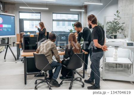 Working on a project together. Designer team are in the office Working on a project together. Designer team are in the office 134704619