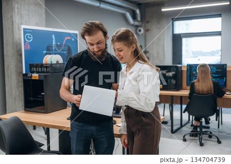 Man and woman are standing. Designer team are together in the office 134704739