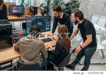 Working on a project together. Designer team are in the office Working on a project together. Designer team are in the office 134704756